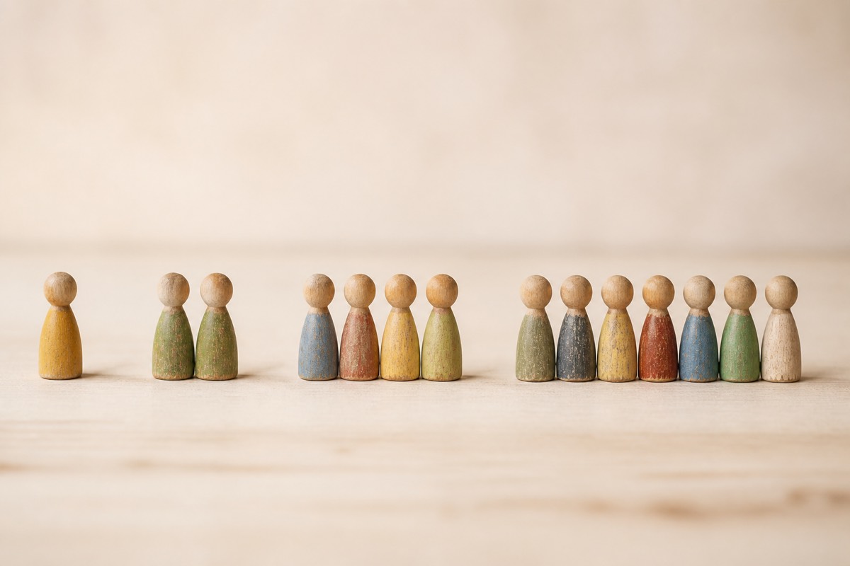 Four groups of wooden figures in a row: one, then two, then four, then seven